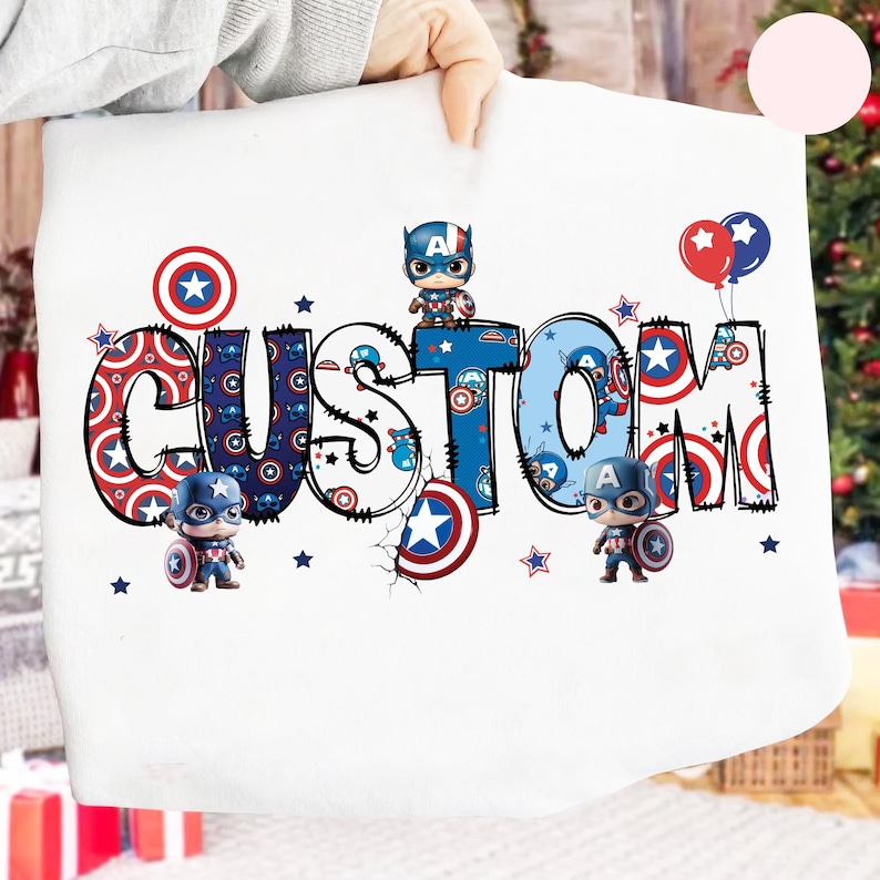May include: White fabric featuring the word "CUSTOM" in a Captain America design. The letters are decorated with Captain America shields and stars. Small Captain America figurines and balloons are also featured.