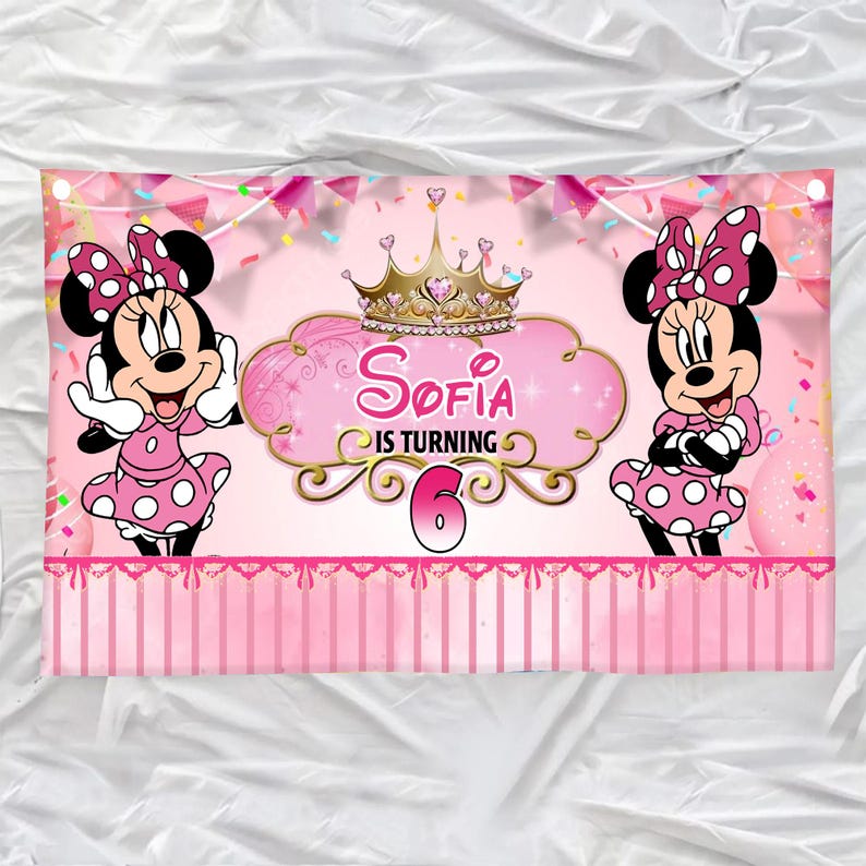 May include: Pink banner featuring Minnie Mouse on either side of a central design. The design includes a gold crown, the name "Sofia", and the phrase "IS TURNING 6". Minnie Mouse is wearing a pink dress with white polka dots and a matching bow.