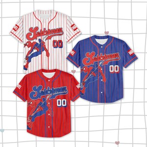 May include: Three baseball jerseys featuring the Spider-Man logo and character illustration. The jerseys are red, white, and blue with vertical stripes. Each jersey has the number "00" on the front.