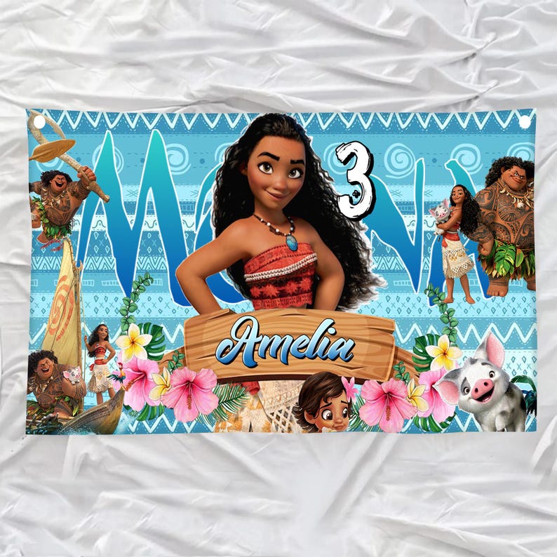 May include: A rectangular banner featuring a blue patterned background with Moana characters, the number 3, and a wooden sign with the name Amelia printed in blue script. The design includes tropical flowers, green leaves, and a small pig character.