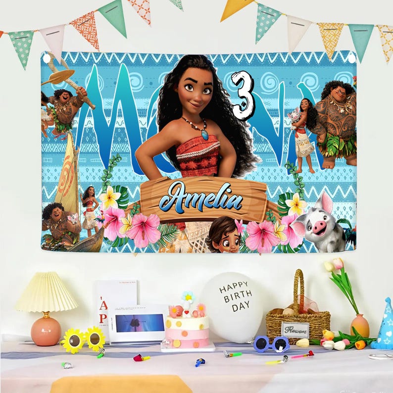 May include: A rectangular birthday banner featuring Moana characters, a large number 3, and the name Amelia on a wooden sign. The background is light blue with tribal patterns, tropical flowers, and green leaves. The banner has grommets at the top corners.