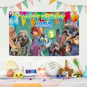 May include: A rectangular birthday banner featuring Zootopia characters, the text HAPPY BIRTHDAY LISA, and a green circle with the number 3. The banner is decorated with colorful balloons and bunting, displayed above a table with party supplies.