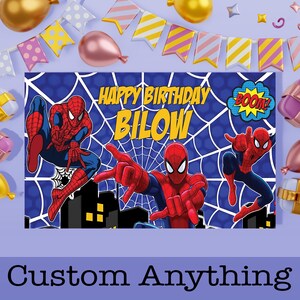 May include: A blue birthday banner featuring Spider-Man illustrations and the text "Happy Birthday Bilow." The banner includes a cityscape silhouette and the word "BOOM!" in a comic book style. The bottom of the banner reads "Custom Anything."