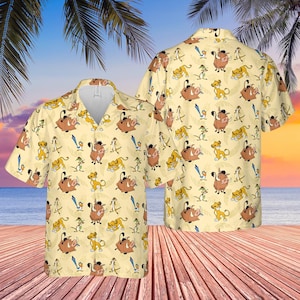 May include: A short-sleeved button-down shirt with a light yellow background and a repeating pattern of cartoon characters. The design features Simba, Timon, Pumbaa, and Zazu. The shirt has a classic collar and a relaxed fit.