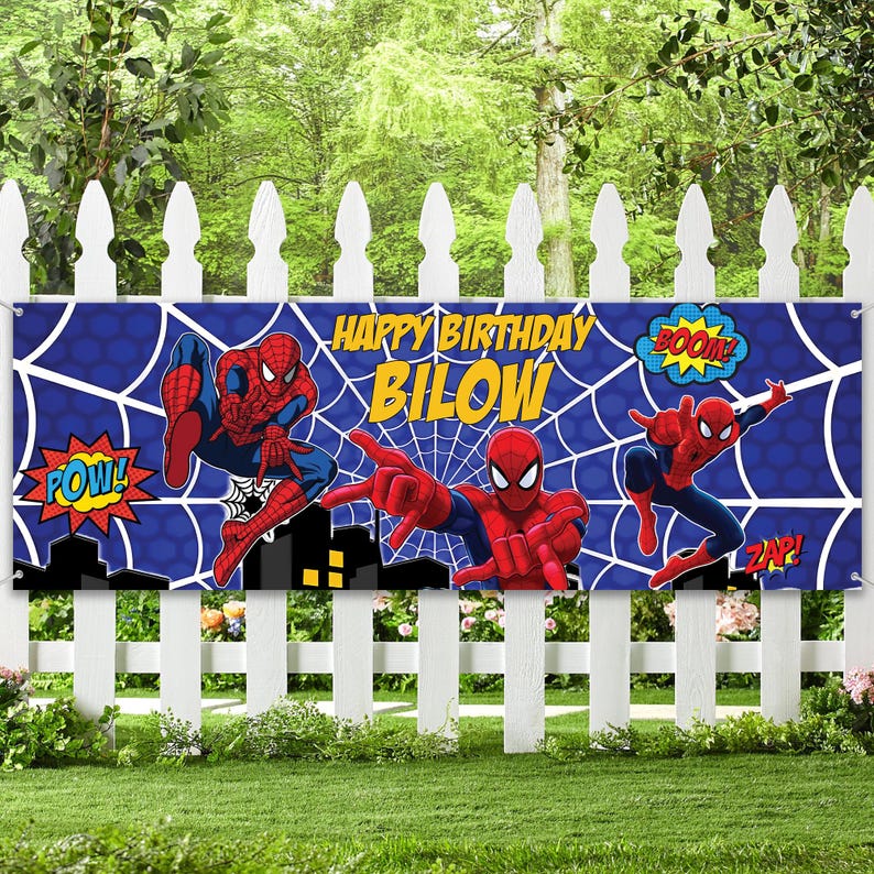 May include: A blue banner with Spider-Man illustrations and the text "HAPPY BIRTHDAY BILOW". The banner features Spider-Man in action poses with comic book sound effects like "POW!", "BOOM!", and "ZAP!" against a web background.