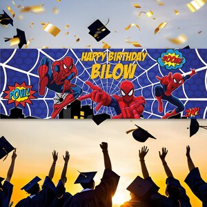 May include: A blue banner with Spider-Man graphics and the text "HAPPY BIRTHDAY BILOW." The banner features Spider-Man in action poses with comic book style sound effects. Graduation caps and gold confetti are in the background.