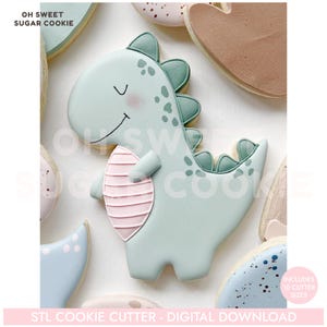 May include: A light green dinosaur-shaped cookie with a pink belly and green accents. The cookie has a smiling face and is surrounded by other cookies. Text on the image reads "OH SWEET SUGAR COOKIE" and "STL COOKIE CUTTER - DIGITAL DOWNLOAD."
