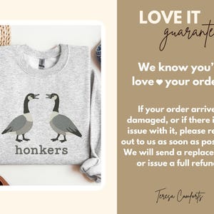 May include: A light gray sweatshirt featuring a graphic of two geese facing each other, with the word "honkers" printed below. The text "LOVE IT guarantee" and other text are also visible.