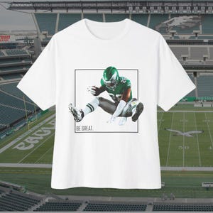 Saquon Barkley Be Great Unisex Shirt | NFL Game Day Shirt | Tailgate Party Clothing | Saquon Barkley Backwards Jump | Eagles Football Fan