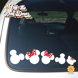 May include: A white car window with a decal of five white Mickey Mouse heads with red polka dot bows. The decal says "Off-the-Wall Decor" in a retro font.
