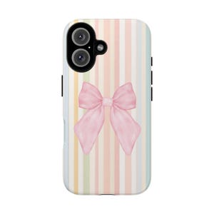May include: A phone case with a pastel striped background and a large pink bow. The case has a dual-lens camera and black side buttons. The bow is centered and has a watercolor effect.