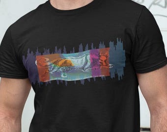 Può includere: T-shirt nero con un design grafico colorato sul petto. Il design presenta una forma rettangolare con tonalità arancioni, rosse e blu. La maglietta è a maniche corte e sembra essere realizzata in un materiale morbido.