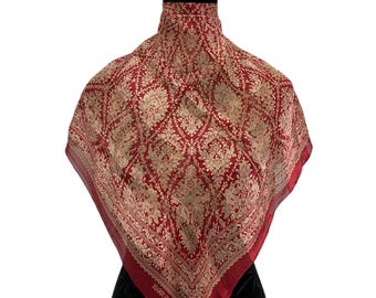 Puede incluir: Un pañuelo cuadrado rojo con un diseño floral dorado y un borde rojo, exhibido en un maniquí. La marca "HARDY AMIES" es visible en el pañuelo.