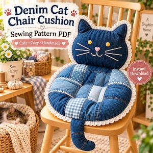 May include: A cat-shaped chair cushion made of blue denim patchwork fabric with a white lace trim. The cushion features yellow button eyes, a pink heart-shaped nose, and white embroidered whiskers. A denim tail extends from the bottom edge.
