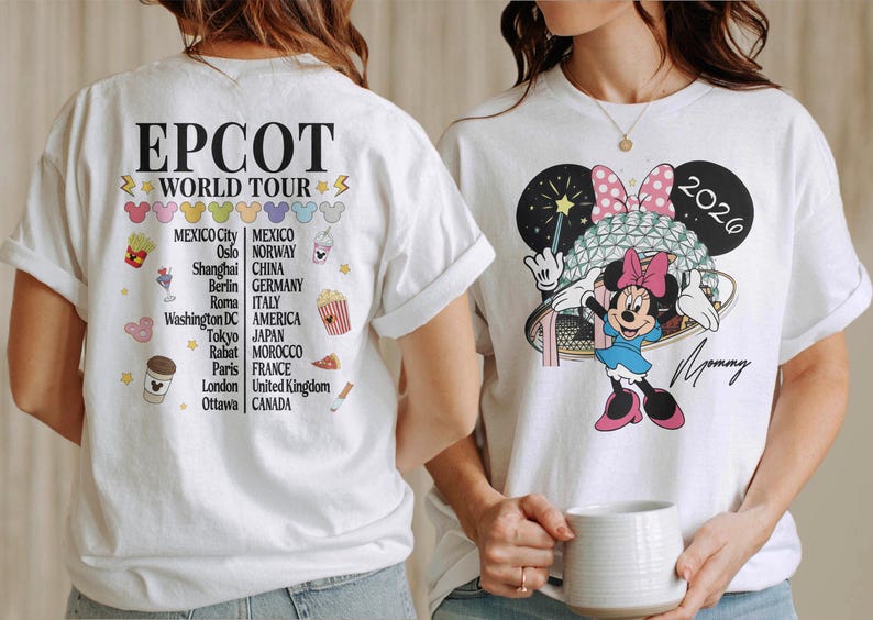 May include: White t-shirts with colorful graphics. One features Minnie Mouse with a bow and the text "2026" and "Mommy." The other shirt has "EPCOT WORLD TOUR" and a list of cities. The shirts are casual wear.
