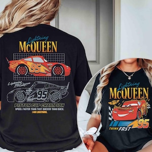 May include: Black t-shirts featuring Lightning McQueen from the Cars movie. The shirts display the text "Lightning McQueen" in a stylized font, along with the number "95" and a graphic of the race car. One shirt also has the text "Piston Cup Champion".