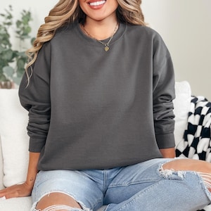 Cozy and customizable, the Gildan 18000 is perfect for fall and winter printing. Soft fleece interior, crewneck style, and durable cotton/poly blend. Add your design with HTV, DTF, or embroidery. A best-seller for seasonal merch, events, and cold-weather comfort. A reliable blank for small shops and bulk sweatshirt orders.