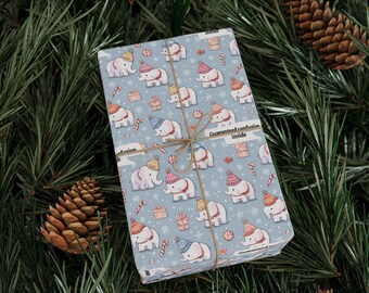 May include: A wrapped gift with a light blue paper featuring a pattern of cartoon elephants wearing winter hats and holding candy canes. The gift is tied with twine and the text "Guaranteed confusion inside" is visible.