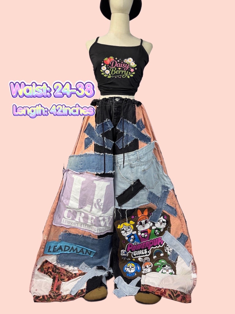 May include: A black crop top with a floral "Daisy Berry" design paired with patchwork denim pants. The pants feature various denim patches, text, and cartoon graphics. Waist: 24-38 inches. Length: 42 inches.