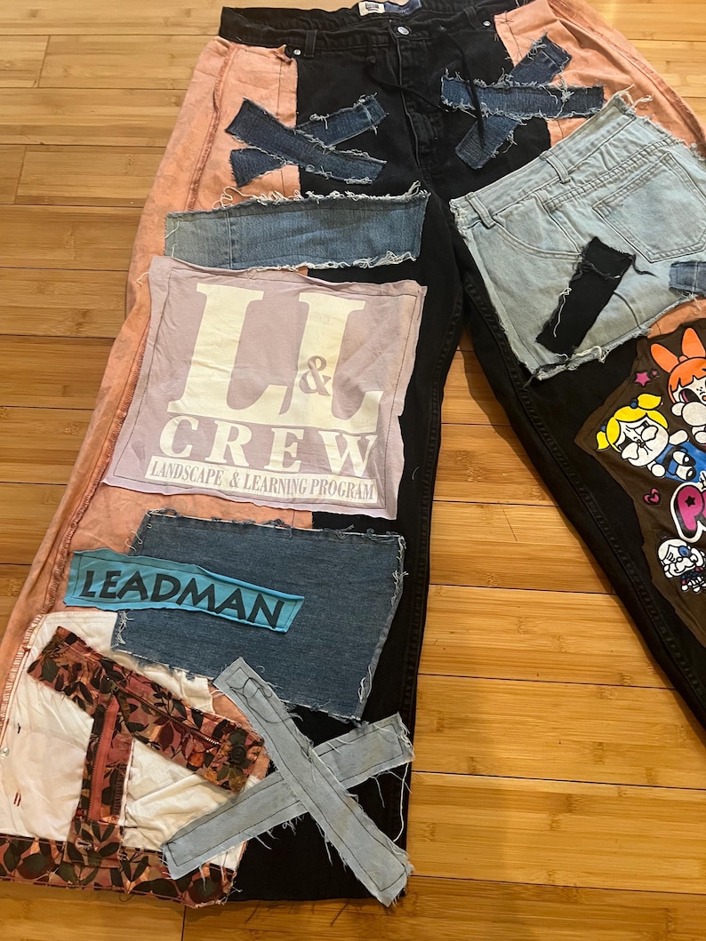 May include: Custom patchwork jeans with a unique design. The jeans feature black, pink, and light blue denim patches, with visible stitching and raw edges. Patches include the text "L & CREW" and "LEADMAN".