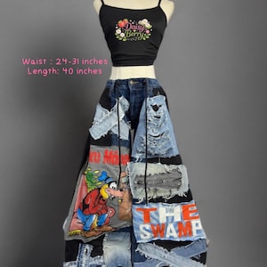 May include: A black tank top with a Daisy Berry graphic and a pair of wide-leg denim pants featuring patchwork, distressed details, a cartoon character print, and the text THE SWAMP. The pants have a waist of 24-31 inches and a length of 40 inches.
