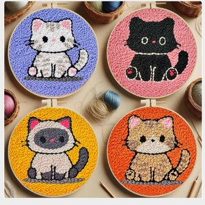 May include: Four colorful cat embroidery hoops. Each hoop features a different cat design: a gray and white tabby on blue, a black cat on pink, a Siamese cat on yellow, and a brown tabby on orange.