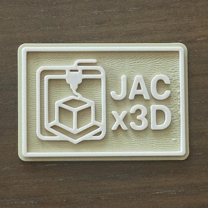 May include: A rectangular patch with a white outline and a light green background. The patch features a 3D printer graphic and the text "JAC x3D" in white. The design is a stylized representation of 3D printing technology.