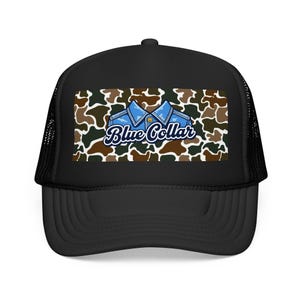 May include: Black trucker hat with a curved peak and mesh back. The front panel displays a camouflage pattern with a blue denim shirt graphic and the words "Blue Collar" in a stylized font.