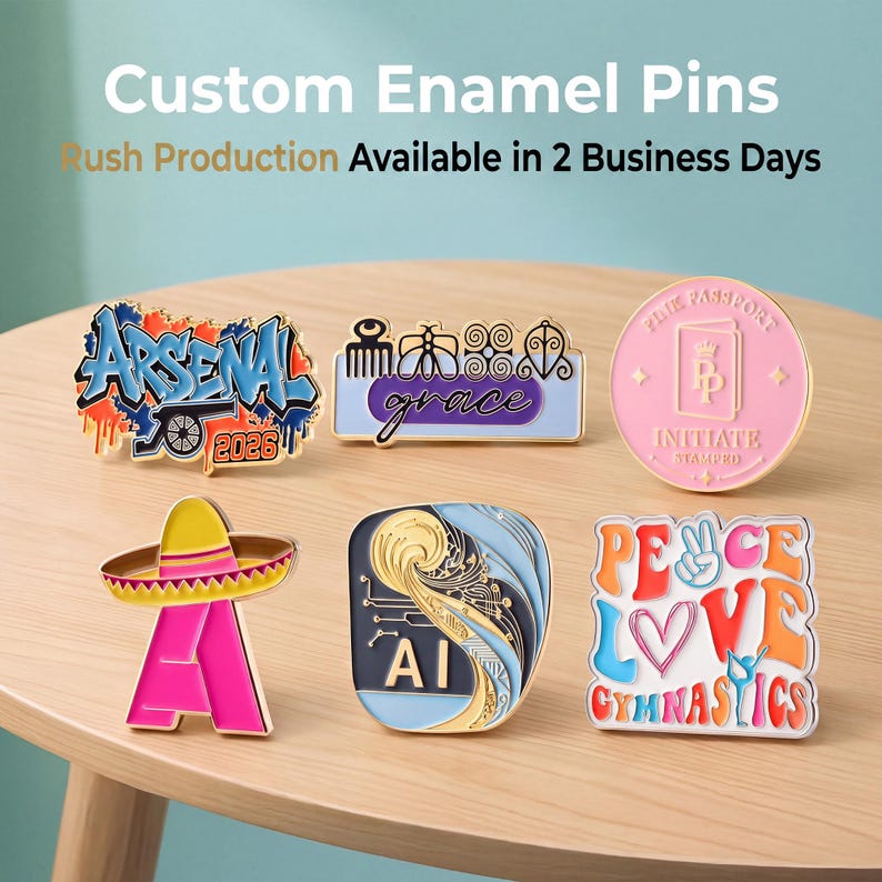May include: Six custom enamel pins featuring various designs: a blue graffiti-style Arsenal 2026 pin, a rectangular pin with symbols and the word grace, a round pink Passport pin, a pink sombrero pin, an AI circuit pin, and a Peace Love Gymnastics pin.