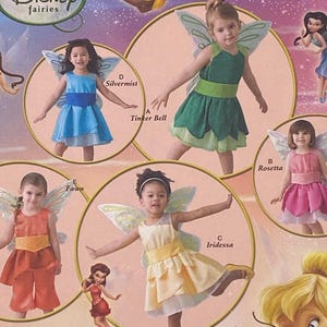 May include: Simplicity Disney Fairies costume pattern. The pattern features illustrations of children in fairy costumes, including Tinker Bell, Silvermist, Rosetta, Fawn, and Iridessa. The pattern number is 2559, and the sizes are A 1/2, 1, 2, 3, and 4.