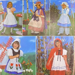 May include: Simplicity Costumes pattern package featuring children's costume designs. The package includes images of various costumes, including Little Red Riding Hood, Alice in Wonderland, and colonial-style outfits. The package has the number 0618 and size AA 3,4,5,6.