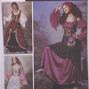 May include: Simplicity Costumes pattern featuring medieval and Renaissance-style dresses. The package includes images of various costume designs, with details like long sleeves, bodices, and skirts. The pattern includes sizes 14, 16, 18, and 20.