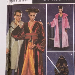 May include: A Simplicity Costumes sewing pattern envelope, number 8944, titled Easy Design Your Own Robe. The packaging features illustrations of various robe styles, including a metallic red and gold robe, a pink robe, and patterned designs.