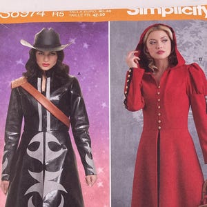 May include: A Simplicity sewing pattern envelope, number 58974, featuring two costume designs. The left shows a black coat with silver flame-like patterns and a cowboy hat. The right shows a long red hooded dress with buttons and long sleeves.