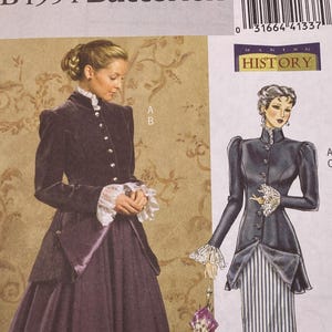 May include: Butterick sewing pattern B4954 for sizes 8-10-12-14. The envelope features illustrations of a long-sleeved jacket with a high collar and button front, paired with a long skirt. One version is solid dark purple, the other has a striped skirt.