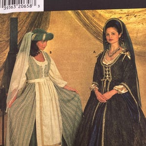 May include: A Simplicity Costumes sewing pattern envelope, number 7756, featuring two historical-style gowns. One gown is green and cream with a headpiece, and the other is dark blue and gold with a veil. The text includes Simplicity Costumes 7756.
