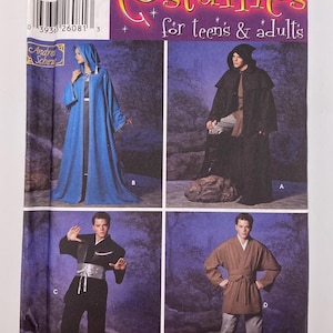 May include: A Simplicity sewing pattern envelope, number 5840, for costumes for teens and adults. The packaging displays four variations of hooded cloaks, robes, and tunics in blue, black, and brown colors, with size range A, M, L, XL printed.