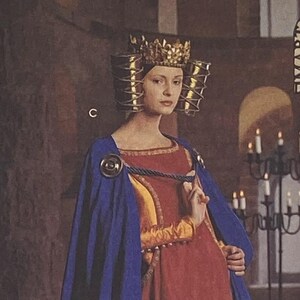 May include: Simplicity Medieval Costume Collection sewing pattern. The pattern features images of medieval costumes, including a long red dress with a blue cape, a white dress with a veil, and a blue and gold head covering. The pattern is labeled "One Size".