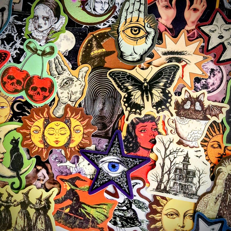 May include: A collection of assorted stickers featuring various illustrations including a black butterfly, a blue eye inside a purple star, skull cherries, a sun face, a black cat on a crescent moon, a haunted house, and a bat in a teacup.