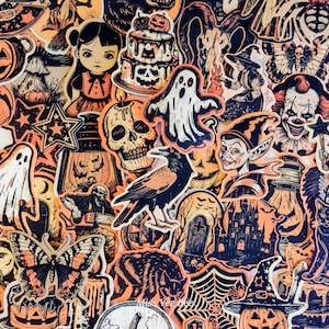 May include: A collection of Halloween-themed stickers in orange, black, and white. The stickers feature ghosts, skulls, a raven, a witch, a clown, a haunted house, and other spooky designs. The stickers are arranged closely together.