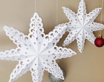 May include: Two white paper snowflake ornaments with intricate cut-out designs hang from strings. The text "SNOWFLAKE TEMPLATE" is above the snowflakes. Red and silver Christmas ornaments are also suspended. The bottom of the image includes the text "- SVG - DXF -" and "- PNG - PDF -".