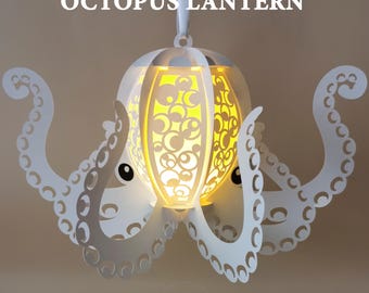 May include: White octopus lantern with a glowing interior. The lantern has a detailed paper cut design and is suspended by a white ribbon. The text "OCTOPUS LANTERN" is at the top. The bottom of the image has the text "- SVG - DXF -" and "- PNG - PDF -".