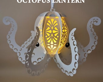 May include: A white paper octopus lantern with a glowing yellow interior. The lantern has a decorative floral pattern and is suspended by a white ribbon. The text "OCTOPUS LANTERN" is at the top.