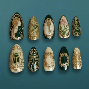May include: A set of ten almond-shaped press-on nails. Each nail features a unique design in gold and dark green, including a woman's profile, a hummingbird, a key, a flower, and other ornate patterns. The nails have a glossy finish.