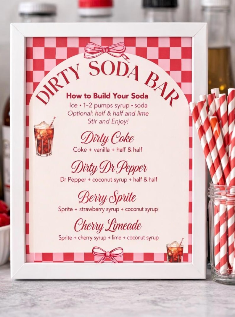 May include: A framed sign with a red and white checkered background and the words "Dirty Soda Bar" in a decorative font. The sign lists soda recipes like Dirty Coke and Berry Sprite. Red and white striped straws are in a glass jar.