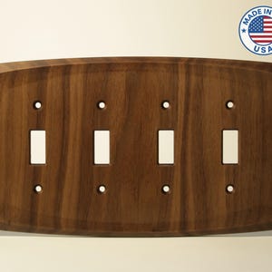 May include: A set of three ceramic mugs with a speckled, cream-colored glaze. Each mug features a different hand-painted design: a blue and green leaf, a yellow flower, and a red berry. The mugs have a simple, rounded shape.