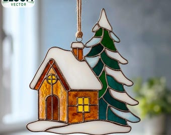 May include: A stained glass Christmas decoration depicting a house and a snow-covered fir tree. The house has a yellow window and a chimney. The ornament hangs from a natural twine string. The Bloom Vector logo is in the upper left corner.