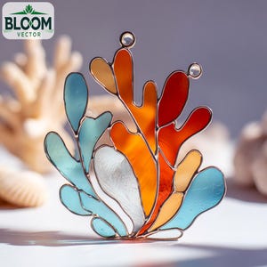 May include: A stained glass coral reef sculpture with vibrant colors. The artwork features shades of orange, red, blue, and white, with a metal frame. The Bloom Vector logo is in the upper left corner. The sculpture is a decorative piece.
