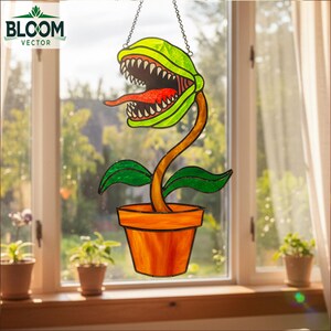 May include: A stained glass plant with a large, toothy mouth and a long red tongue. The plant is in an orange pot and has green leaves. The image includes the text "BLOOM VECTOR" in the upper left corner. The plant is hanging from a chain.