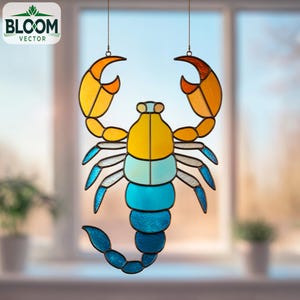 May include: A colourful stained glass scorpion suncatcher, featuring yellow, orange, blue, and teal segments. The scorpion has large claws and a curved tail. The Bloom Vector logo is in the upper left corner. It hangs from a thin chain.